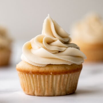 Moist vanilla cupcakes with buttercream frosting are soft, fluffy, simple, sweet, and delicious. Secret ingredient yogurt keeps them moist for days! | aheadofthyme.com