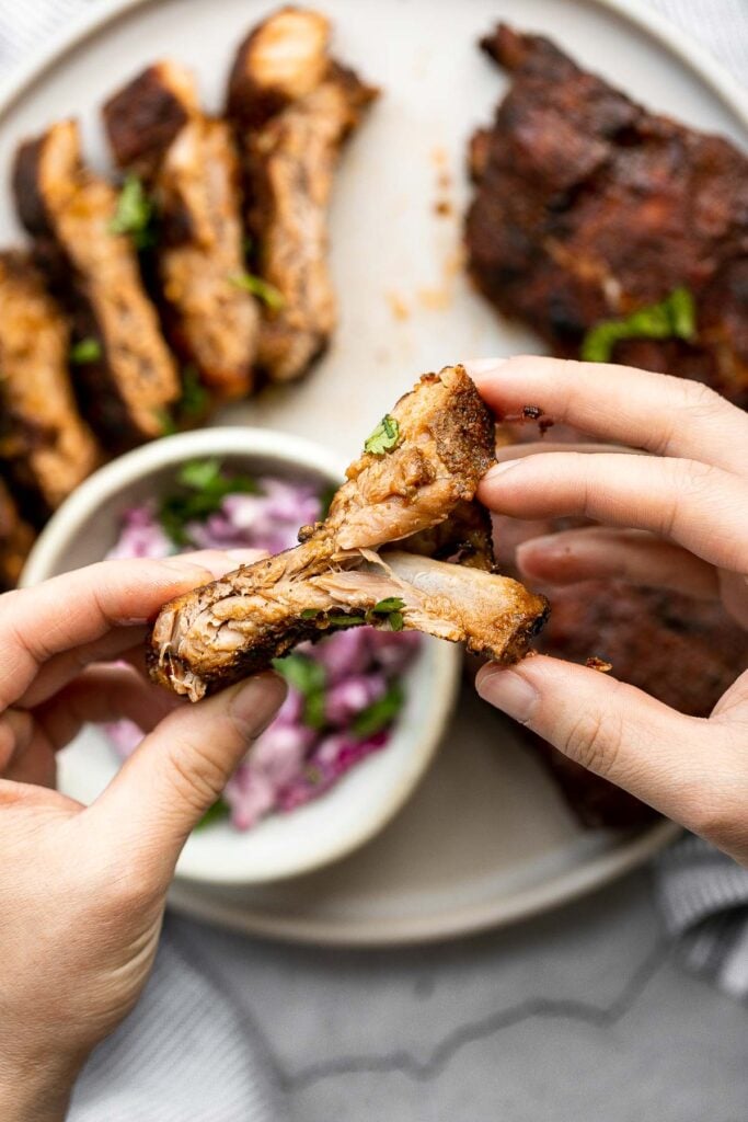 Slow cooker BBQ ribs are juicy, saucy, and tender -- the meat literally falls right off the bone. Add this easy recipe to your list of crockpot recipes. | aheadofthyme.com