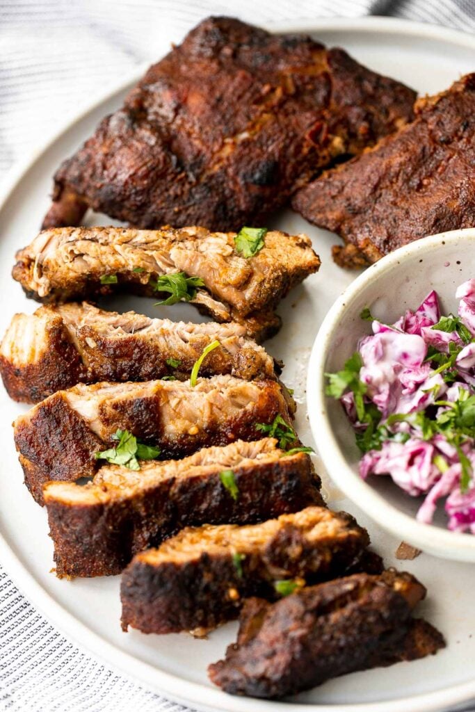 Slow cooker BBQ ribs are juicy, saucy, and tender -- the meat literally falls right off the bone. Add this easy recipe to your list of crockpot recipes. | aheadofthyme.com