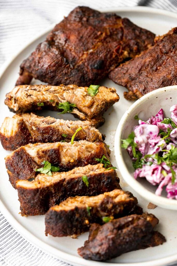 Slow cooker BBQ ribs are juicy, saucy, and tender -- the meat literally falls right off the bone. Add this easy recipe to your list of crockpot recipes. | aheadofthyme.com