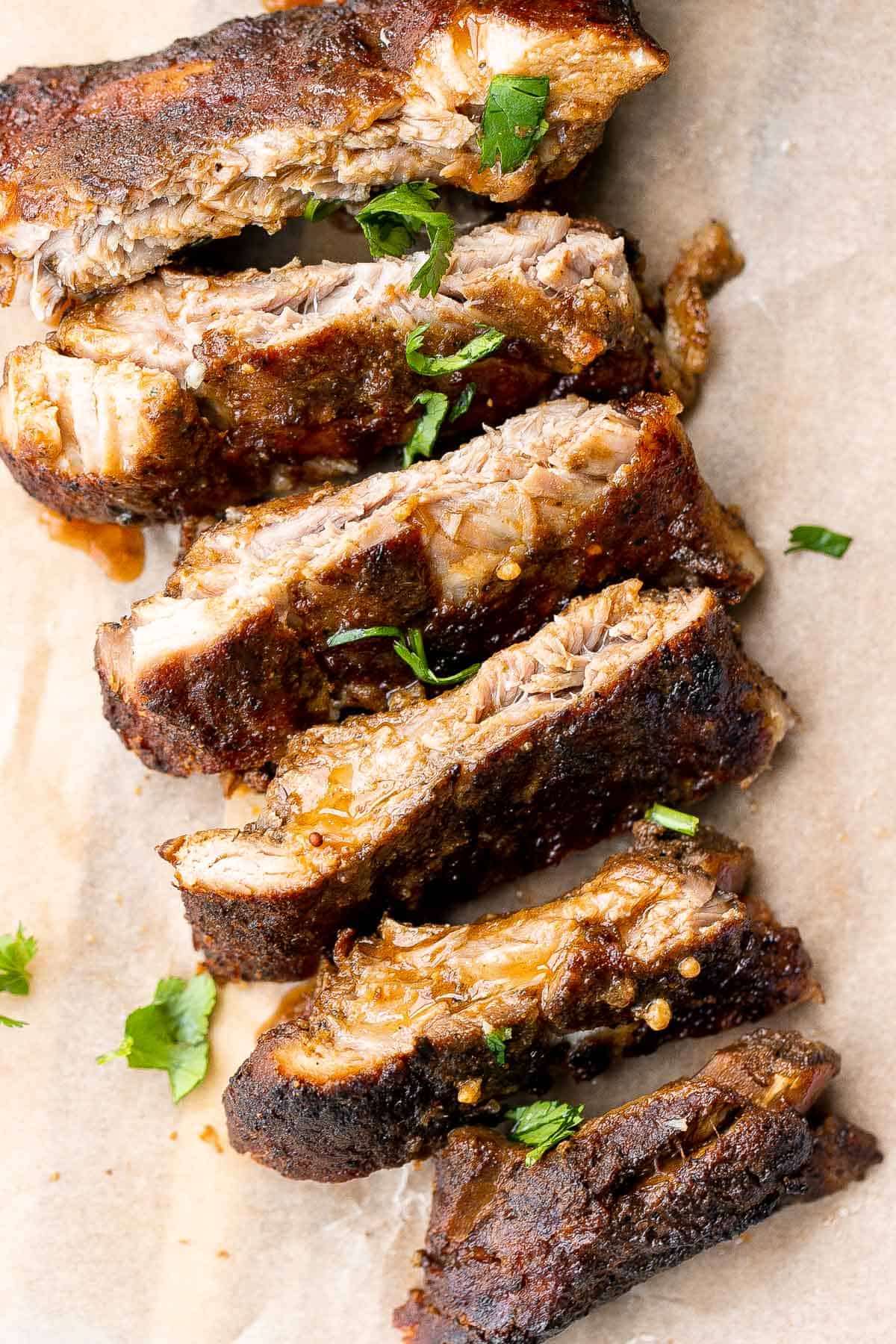 Slow cooker BBQ ribs are juicy, saucy, and tender -- the meat literally falls right off the bone. Add this easy recipe to your list of crockpot recipes. | aheadofthyme.com