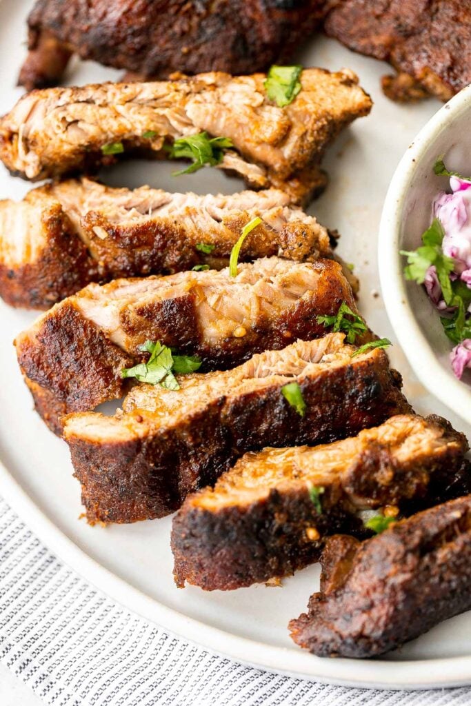 Slow cooker BBQ ribs are juicy, saucy, and tender -- the meat literally falls right off the bone. Add this easy recipe to your list of crockpot recipes. | aheadofthyme.com