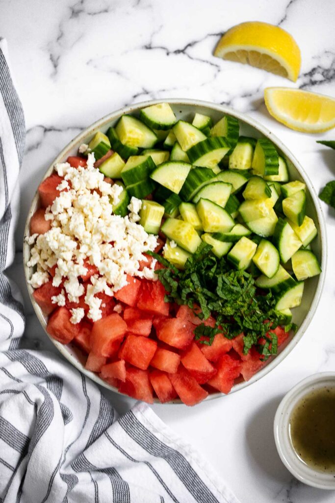 Watermelon feta salad with cucumbers and mint is a simple and delicious refreshing summer salad that you can toss together in 5 minutes. | aheadofthyme.com