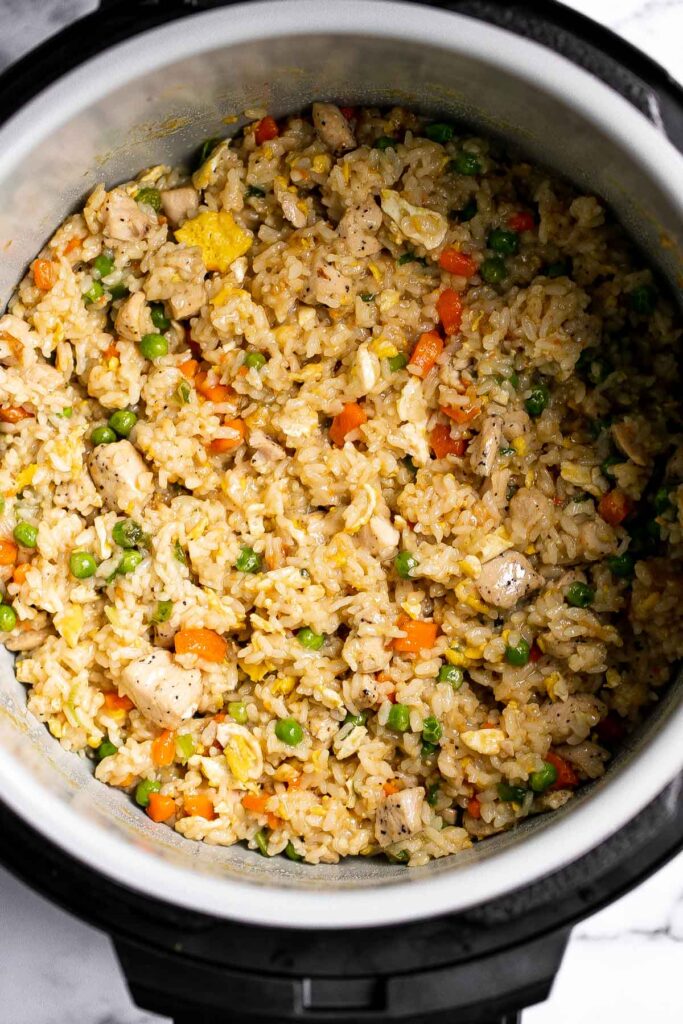 Instant pot chicken fried rice is easy to throw together, packed with flavor, and delicious. It's perfect for a weeknight family dinner or meal prep. | aheadofthyme.com