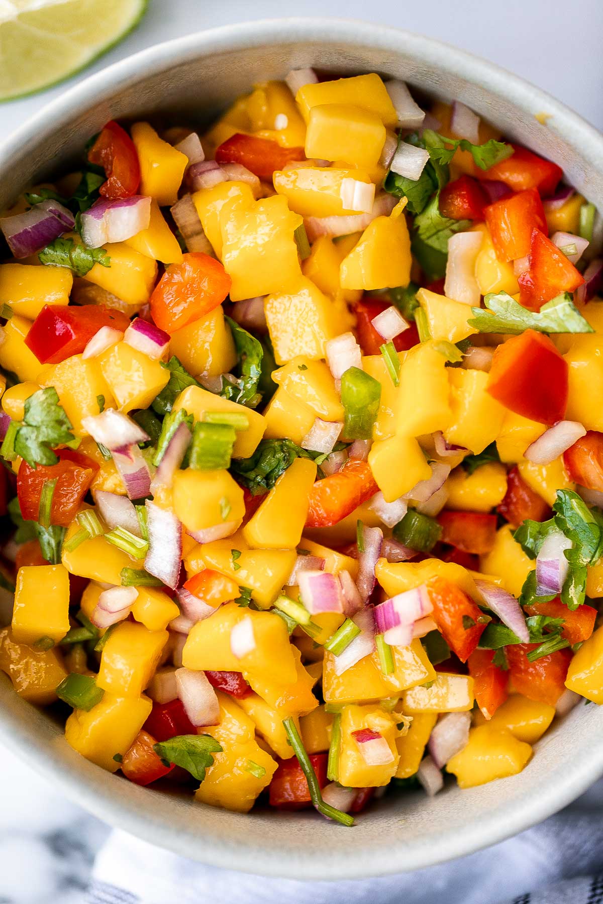 Fresh mango salsa is sweet, tangy, and delicious. It's a quick and easy recipe that you can whip up with just 6 ingredients and in under 10 minutes. | aheadofthyme.com