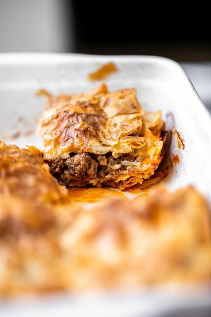 Phyllo meat pie (Egyptian goulash) is a savory pie made of well-seasoned ground beef that lies between layers of flaky, crispy, golden phyllo pastry dough. | aheadofthyme.com