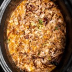 Crispy, shredded slow cooker carnitas (pulled pork) are a Mexican favorite that you can make at home. Packed with flavor, easy to make, and minimal dishes. | aheadofthyme.com