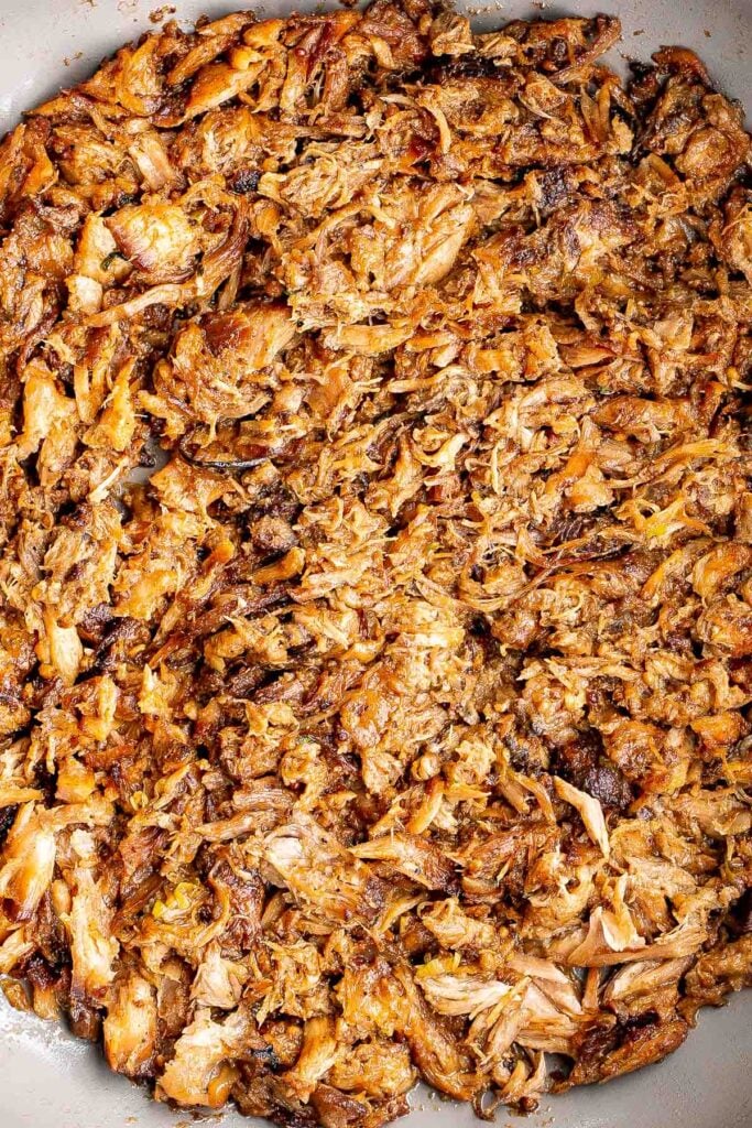 Crispy, shredded slow cooker carnitas (pulled pork) are a Mexican favorite that you can make at home. Packed with flavor, easy to make, and minimal dishes. | aheadofthyme.com