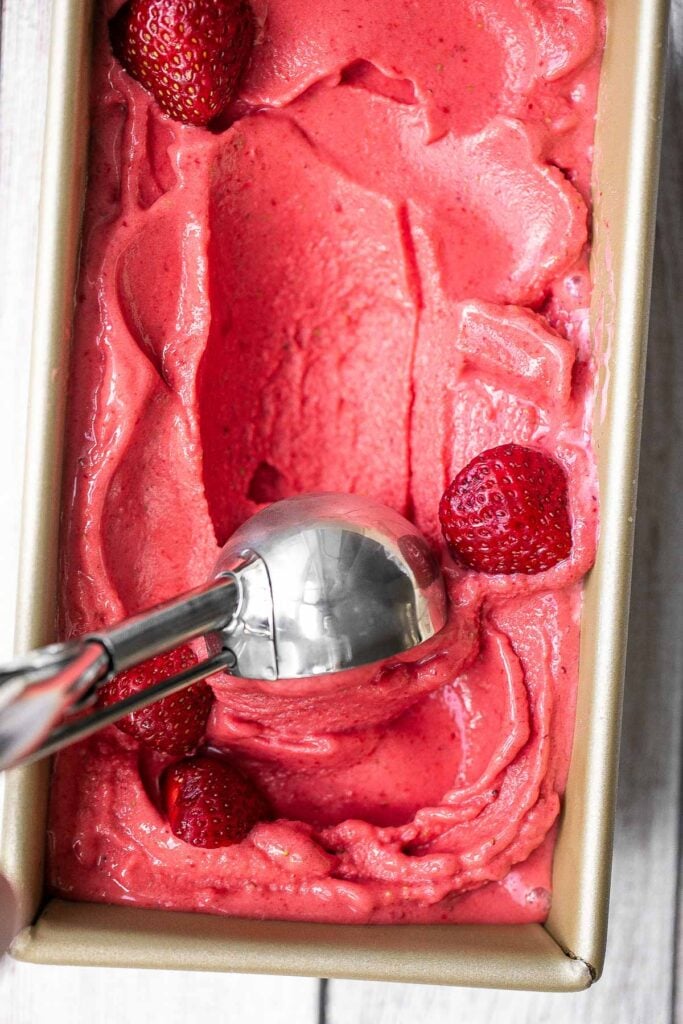 Homemade strawberry frozen yogurt is a delicious, refreshing, healthy dessert made with 4 simple ingredients, no refined sugar, and in less than 5 minutes. | aheadofthyme.com