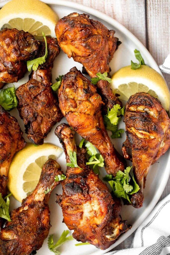 Tandoori chicken drumsticks are crispy outside, juicy and tender inside, and packed with flavor. An easy dinner to make in the oven, stovetop, or grill. | aheadofthyme.com