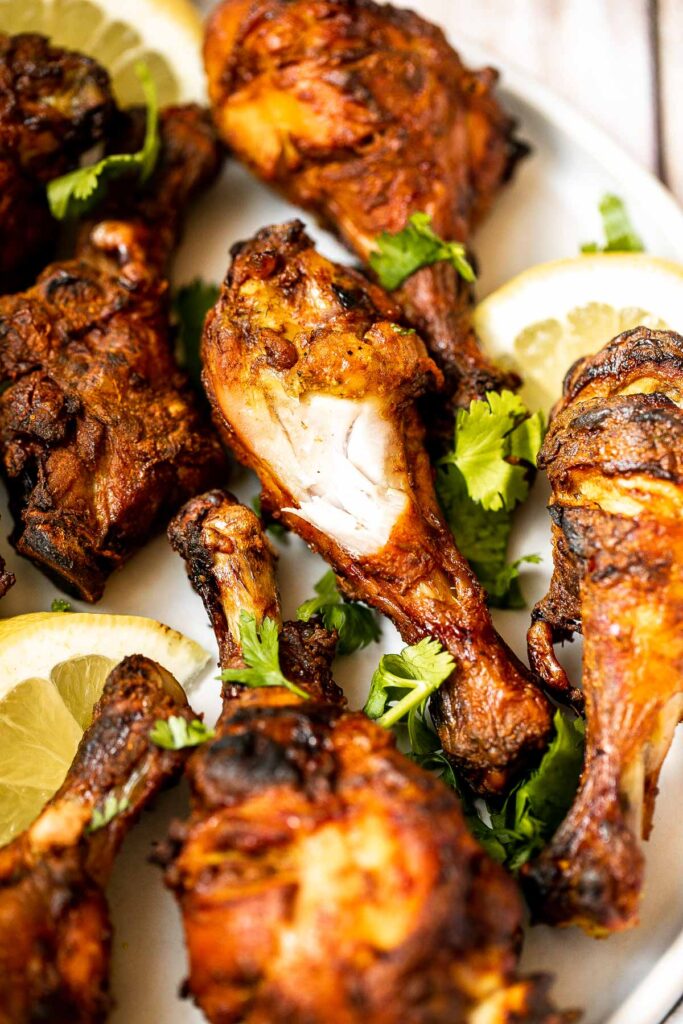 Tandoori chicken drumsticks are crispy outside, juicy and tender inside, and packed with flavor. An easy dinner to make in the oven, stovetop, or grill. | aheadofthyme.com