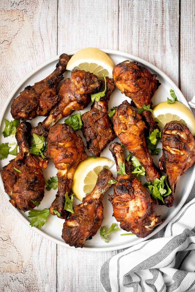 Tandoori chicken drumsticks are crispy outside, juicy and tender inside, and packed with flavor. An easy dinner to make in the oven, stovetop, or grill. | aheadofthyme.com