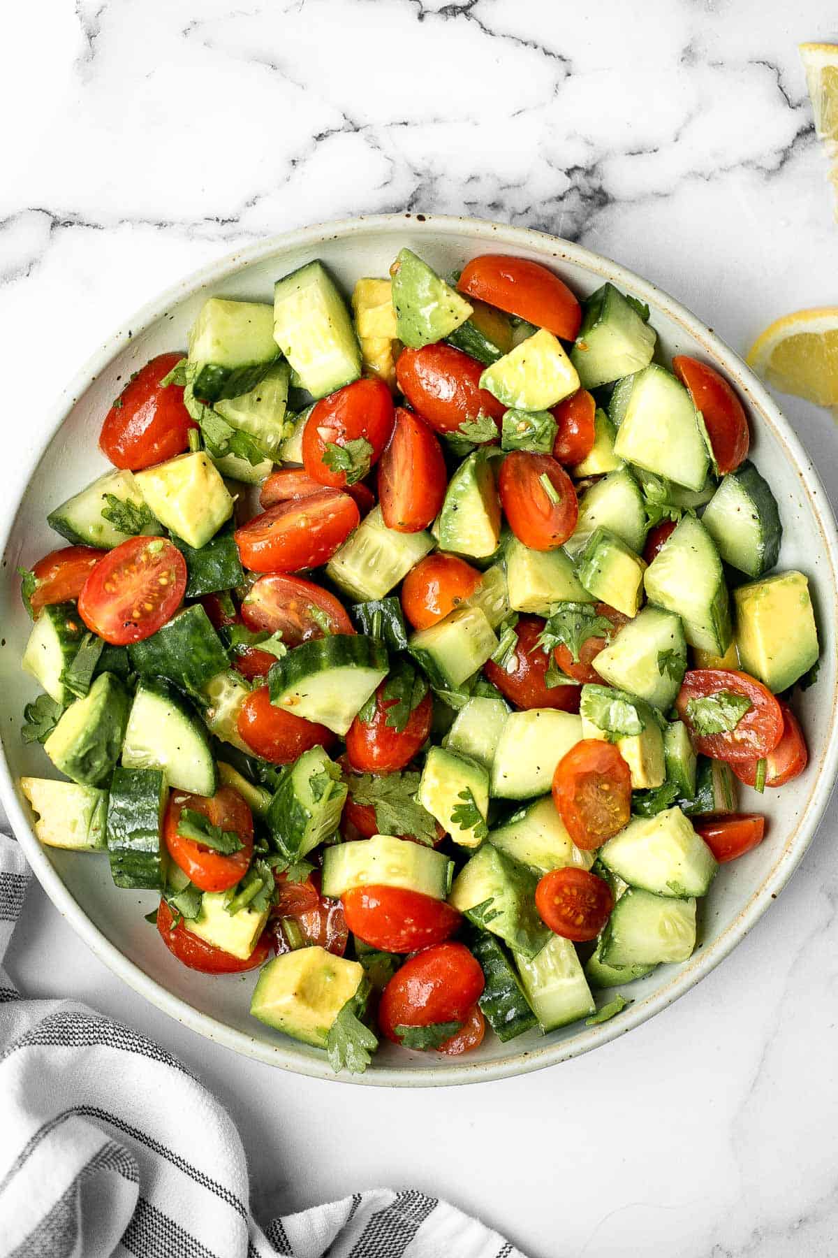 Simple tomato cucumber avocado salad with a delicious lemon vinaigrette is a light and refreshing salad that comes together in literally 5 minutes. | aheadofthyme.com