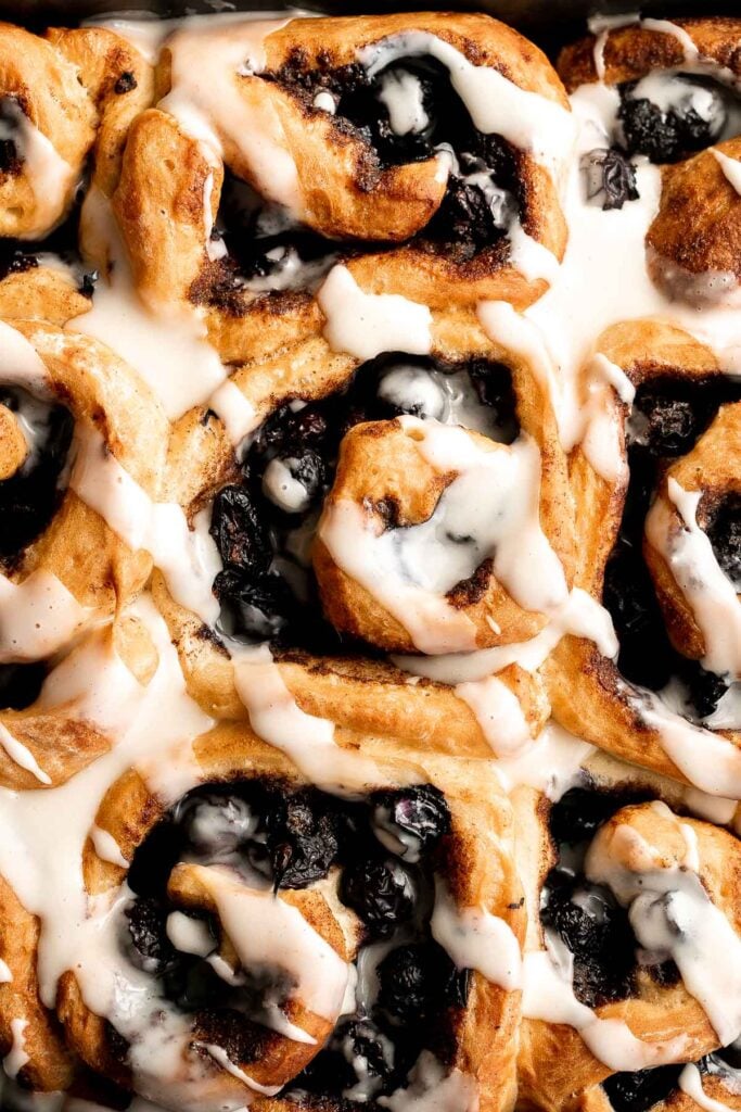 Delicious blueberry cinnamon rolls are soft and fluffy, filled with cinnamon sugar, loaded with fresh blueberries, and topped with cream cheese icing. | aheadofthyme.com