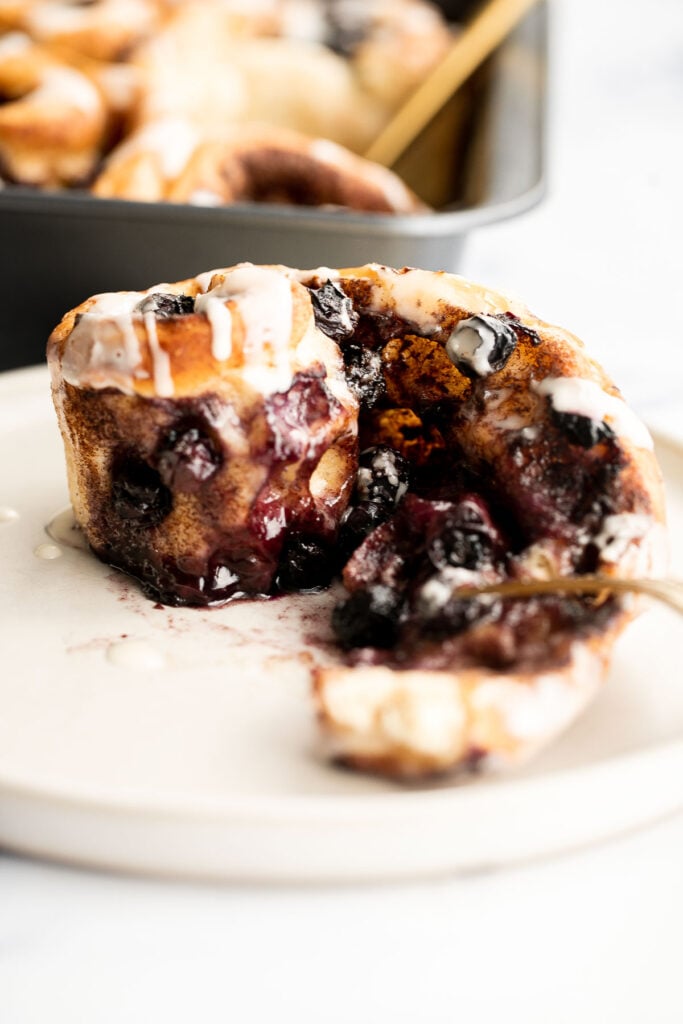 Delicious blueberry cinnamon rolls are soft and fluffy, filled with cinnamon sugar, loaded with fresh blueberries, and topped with cream cheese icing. | aheadofthyme.com