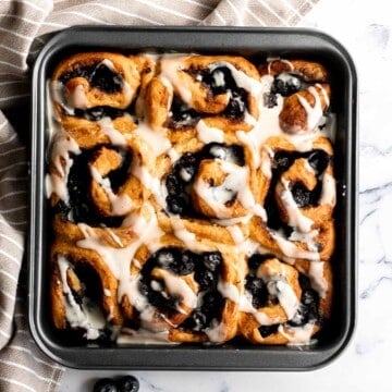 Delicious blueberry cinnamon rolls are soft and fluffy, filled with cinnamon sugar, loaded with fresh blueberries, and topped with cream cheese icing. | aheadofthyme.com