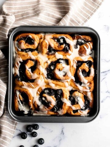 Delicious blueberry cinnamon rolls are soft and fluffy, filled with cinnamon sugar, loaded with fresh blueberries, and topped with cream cheese icing. | aheadofthyme.com
