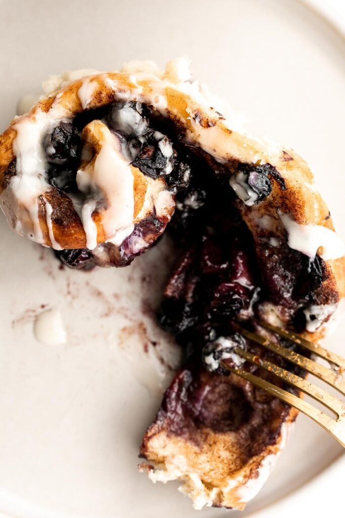 Delicious blueberry cinnamon rolls are soft and fluffy, filled with cinnamon sugar, loaded with fresh blueberries, and topped with cream cheese icing. | aheadofthyme.com