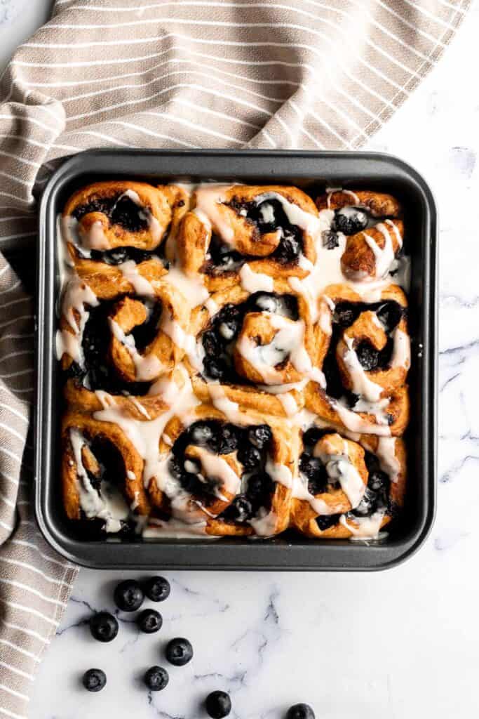 Delicious blueberry cinnamon rolls are soft and fluffy, filled with cinnamon sugar, loaded with fresh blueberries, and topped with cream cheese icing. | aheadofthyme.com