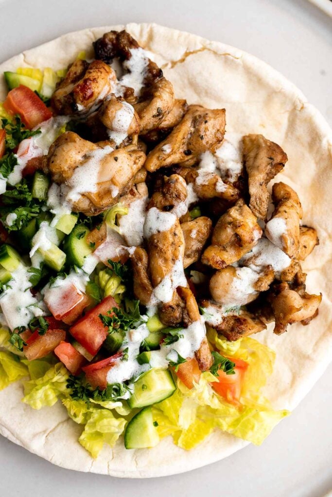 Homemade chicken shawarma (donair) with juicy tender chicken marinated in Middle Eastern spices and wrapped in pita bread is easy to make at home. | aheadofthyme.com