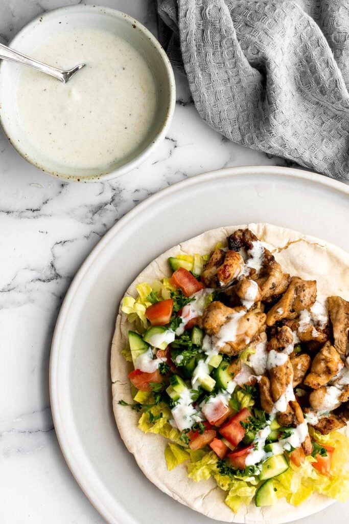 Homemade chicken shawarma (donair) with juicy tender chicken marinated in Middle Eastern spices and wrapped in pita bread is easy to make at home. | aheadofthyme.com