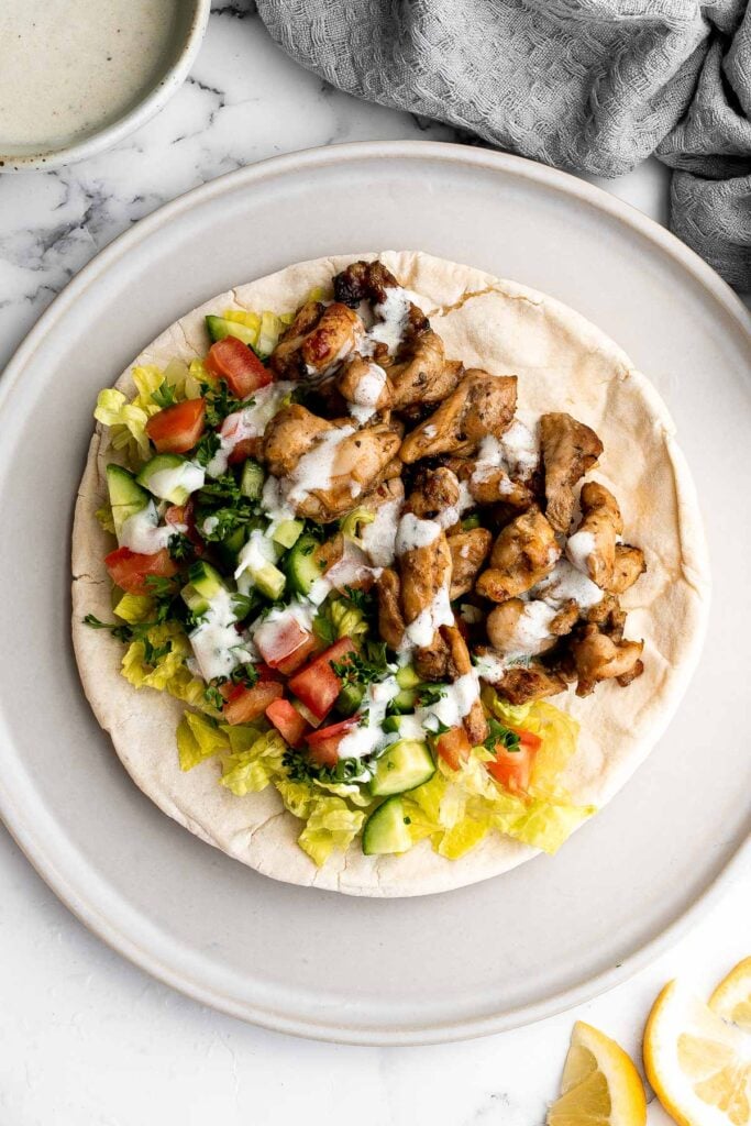 Homemade chicken shawarma (donair) with juicy tender chicken marinated in Middle Eastern spices and wrapped in pita bread is easy to make at home. | aheadofthyme.com