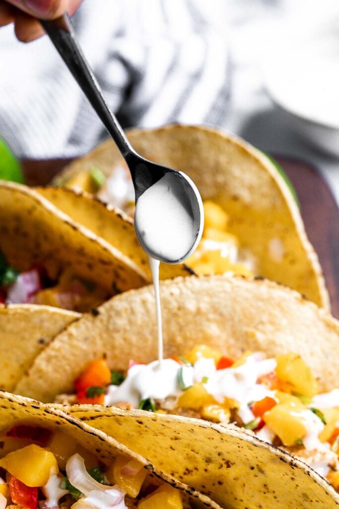 Fish stick tacos are fun, quick, easy, and delicious. Crispy breaded fish sticks are topped with a homemade mango salsa and a drizzle of lime crema. | aheadofthyme.com