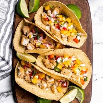 Fish stick tacos are fun, quick, easy, and delicious. Crispy breaded fish sticks are topped with a homemade mango salsa and a drizzle of lime crema. | aheadofthyme.com