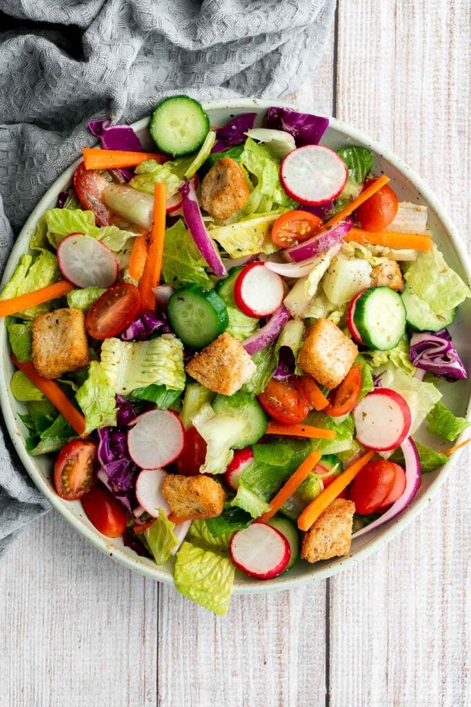 Quick easy homemade garden salad is simple and delicious. Ready in minutes, it's loaded with crisp leafy greens, fresh garden veggies, and crunchy croutons. | aheadofthyme.com