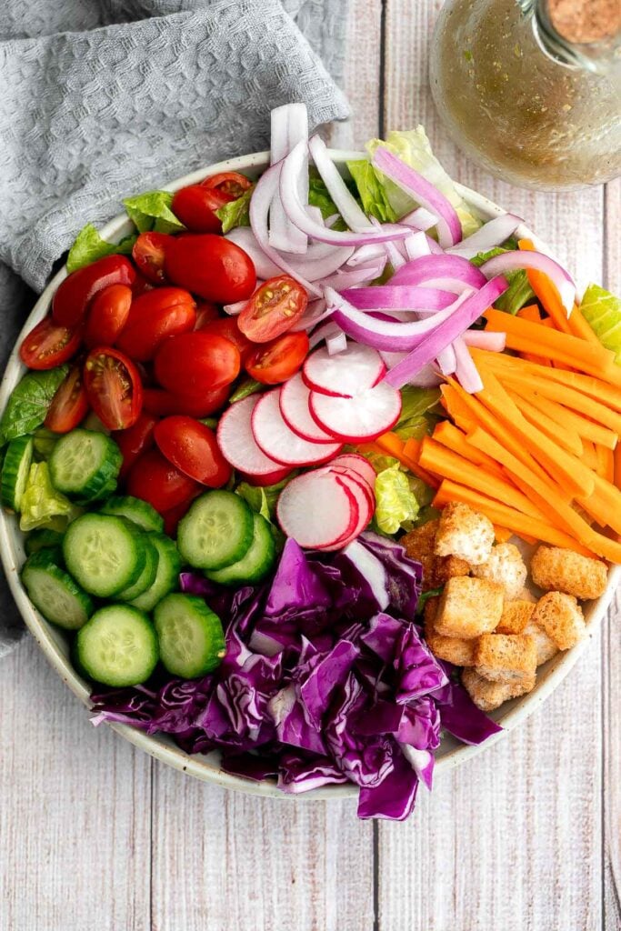 Quick easy homemade garden salad is simple and delicious. Ready in minutes, it's loaded with crisp leafy greens, fresh garden veggies, and crunchy croutons. | aheadofthyme.com