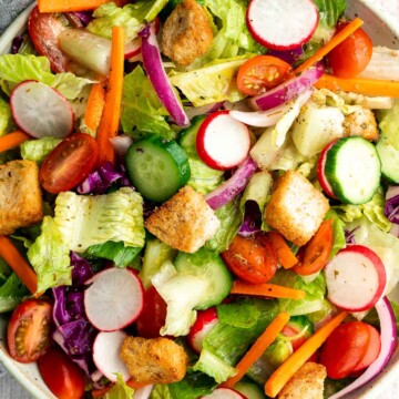 Quick easy homemade garden salad is simple and delicious. Ready in minutes, it's loaded with crisp leafy greens, fresh garden veggies, and crunchy croutons. | aheadofthyme.com