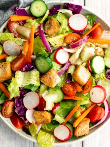 Quick easy homemade garden salad is simple and delicious. Ready in minutes, it's loaded with crisp leafy greens, fresh garden veggies, and crunchy croutons. | aheadofthyme.com