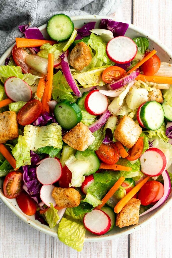 Quick easy homemade garden salad is simple and delicious. Ready in minutes, it's loaded with crisp leafy greens, fresh garden veggies, and crunchy croutons. | aheadofthyme.com