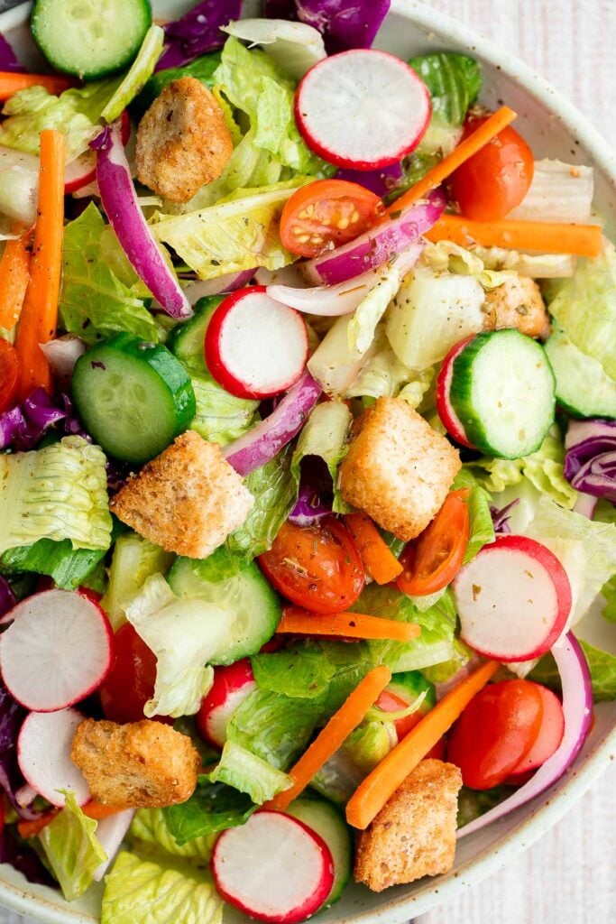 Quick easy homemade garden salad is simple and delicious. Ready in minutes, it's loaded with crisp leafy greens, fresh garden veggies, and crunchy croutons. | aheadofthyme.com