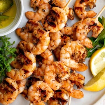 Garlic shrimp skewers are delicious and full of fresh flavor. These quick and easy kabobs can be grilled, baked or air fried for an easy summer dinner. | aheadofthyme.com