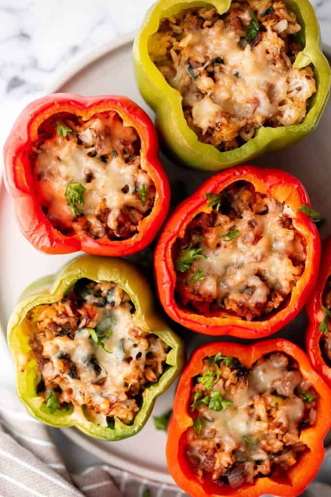 Ground beef stuffed peppers are delicious, healthy, and filling. Stuffed with beef rice and veggies, they're easy to make ahead and freezer-friendly. | aheadofthyme.com