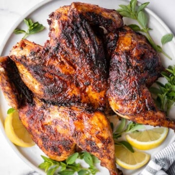 Harissa spatchcock chicken (butterflied chicken) is juicy and tender, has the crispiest skin, and is packed with flavor from red pepper harissa paste. | aheadofthyme.com