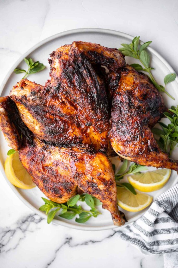 Harissa spatchcock chicken (butterflied chicken) is juicy and tender, has the crispiest skin, and is packed with flavor from red pepper harissa paste. | aheadofthyme.com