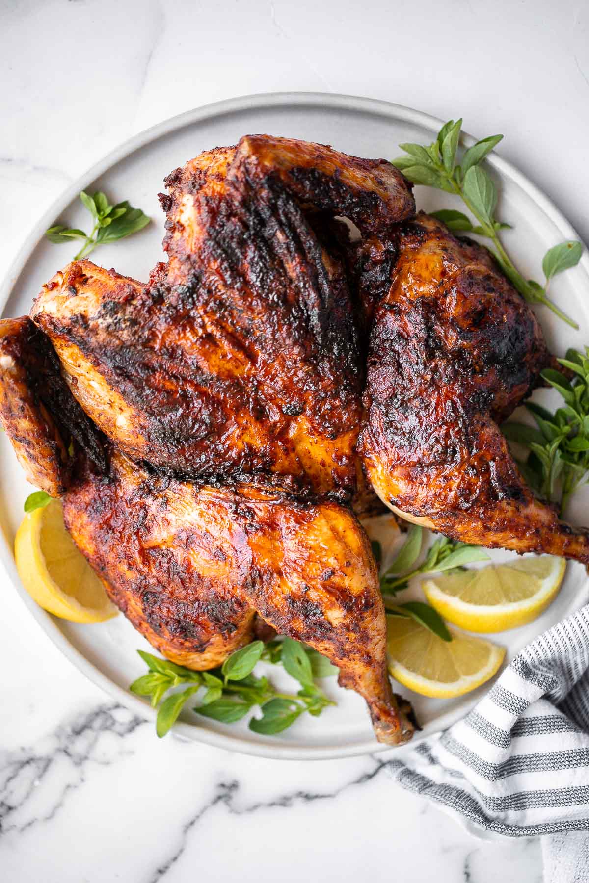 Harissa spatchcock chicken (butterflied chicken) is juicy and tender, has the crispiest skin, and is packed with flavor from red pepper harissa paste. | aheadofthyme.com