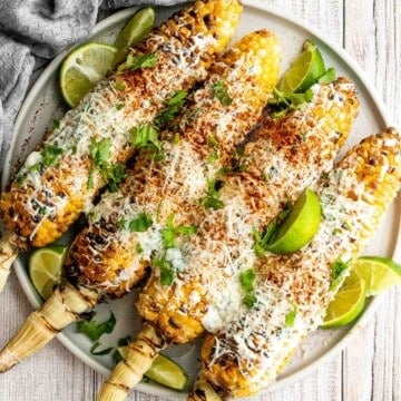 Mexican street corn (elote) is a delicious corn on the cob loaded with a cheesy sauce elevated with cilantro and lime. Creamy, cheesy, spicy, and flavorful. | aheadofthyme.com