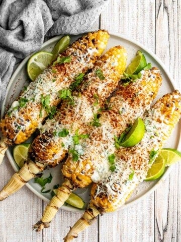 Mexican street corn (elote) is a delicious corn on the cob loaded with a cheesy sauce elevated with cilantro and lime. Creamy, cheesy, spicy, and flavorful. | aheadofthyme.com