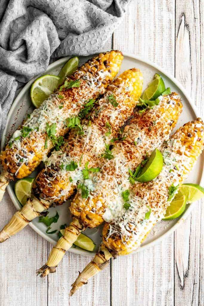 Mexican street corn (elote) is a delicious corn on the cob loaded with a cheesy sauce  elevated with cilantro and lime. Creamy, cheesy, spicy, and flavorful. | aheadofthyme.com