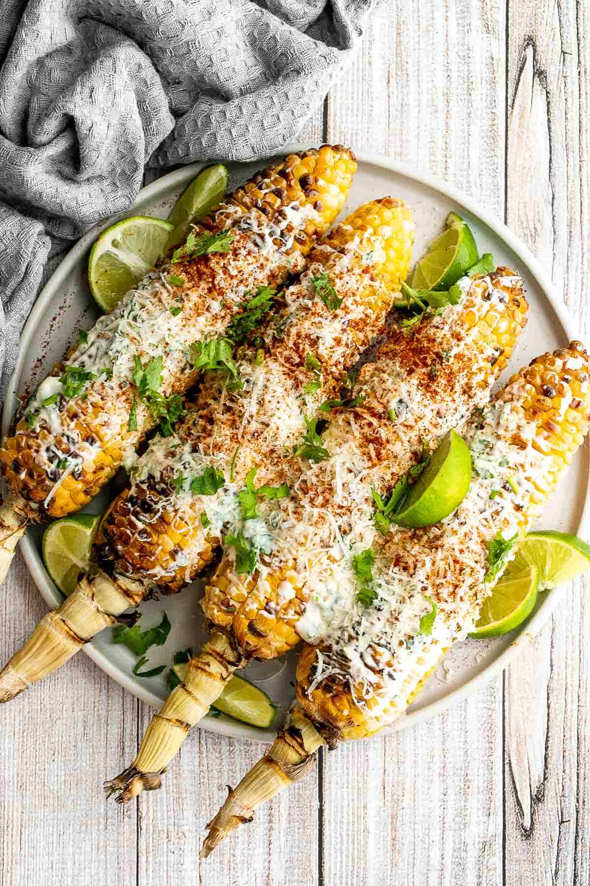 Mexican street corn (elote) is a delicious corn on the cob loaded with a cheesy sauce elevated with cilantro and lime. Creamy, cheesy, spicy, and flavorful. | aheadofthyme.com