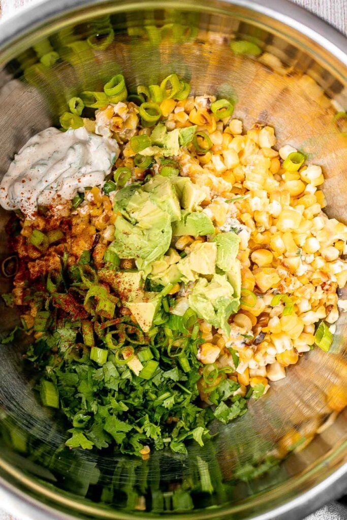 Mexican street corn salad adds a twist to a classic street food, loaded with freshly grilled corn, a creamy cheesy dressing, and authentic flavor. | aheadofthyme.com