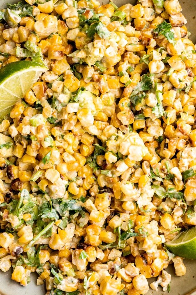 Mexican street corn salad adds a twist to a classic street food, loaded with freshly grilled corn, a creamy cheesy dressing, and authentic flavor. | aheadofthyme.com