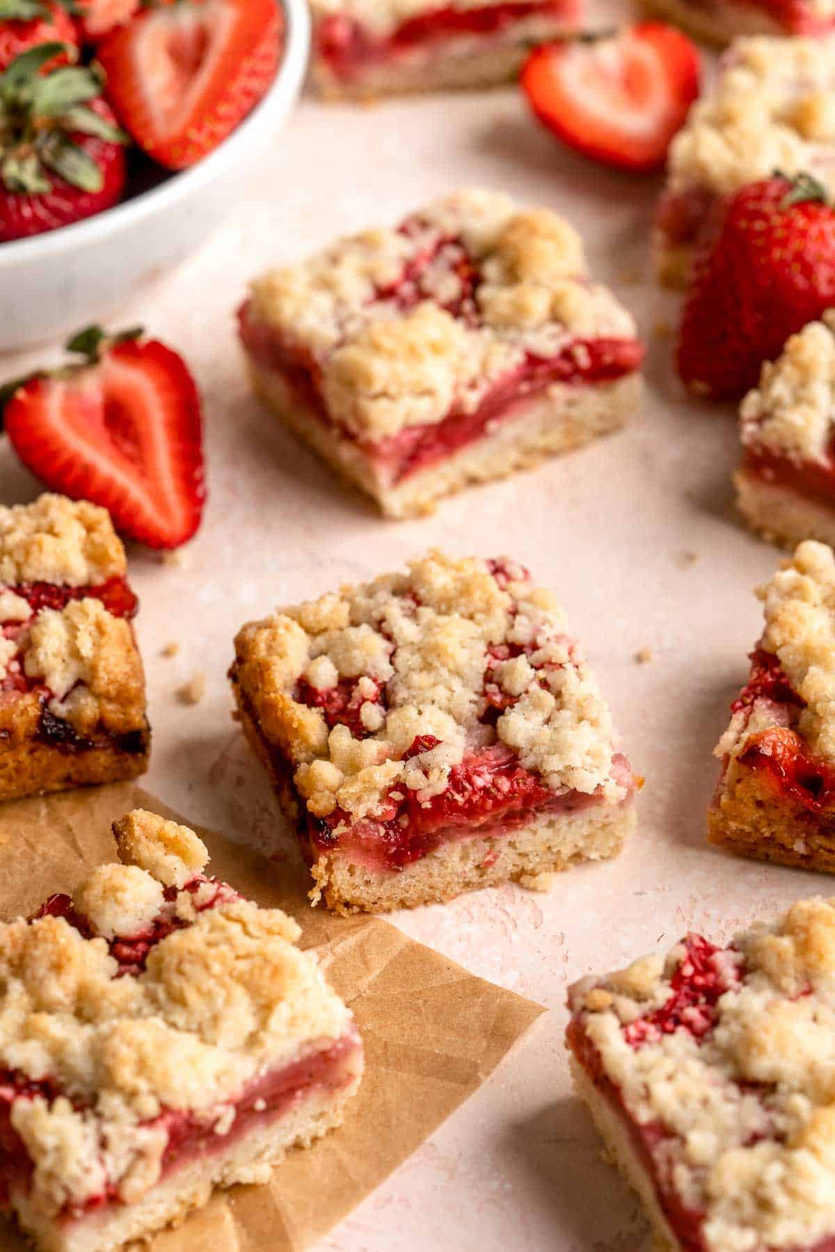 Strawberry Crumb Bars are sweet, savory, and tart homemade bars made with a layer of jammy strawberries sandwiched between two crumbly pastry layers. | aheadofthyme.com