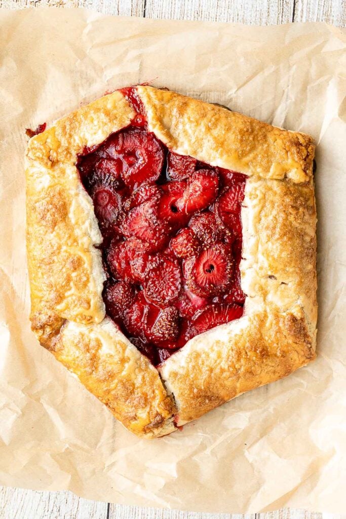 Easier than pie, this strawberry galette with a buttery flaky crust and a sweet and tart strawberry filling is a beautiful treat to serve this berry season. | aheadofthyme.com