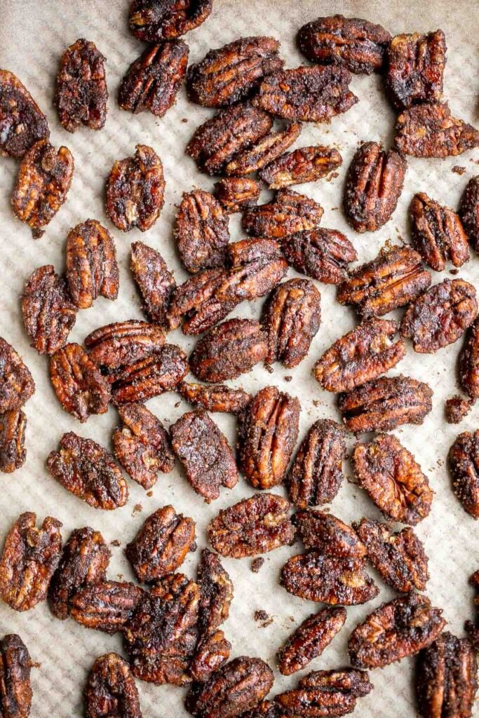 Candied pecans are a delicious, crunchy, and sweet snack during the holidays or great topped on salads and more. Made with five pantry staple in 10 minutes. | aheadofthyme.com