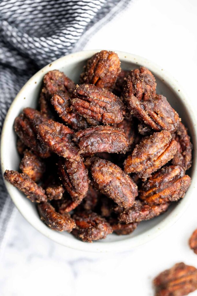 Candied pecans are a delicious, crunchy, and sweet snack during the holidays or great topped on salads and more. Made with five pantry staple in 10 minutes. | aheadofthyme.com