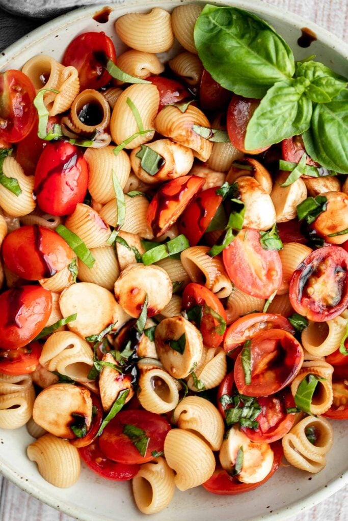 Bright and colorful caprese pasta salad is the ultimate summer side dish. It's fresh, light, and loaded with vibrant summer flavors. Quick and easy too! | aheadofthyme.com